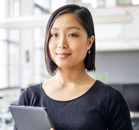 smiling woman holding tablet computer
